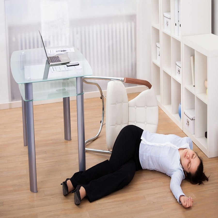 exhausted businesswoman fainted on floor at workplace
